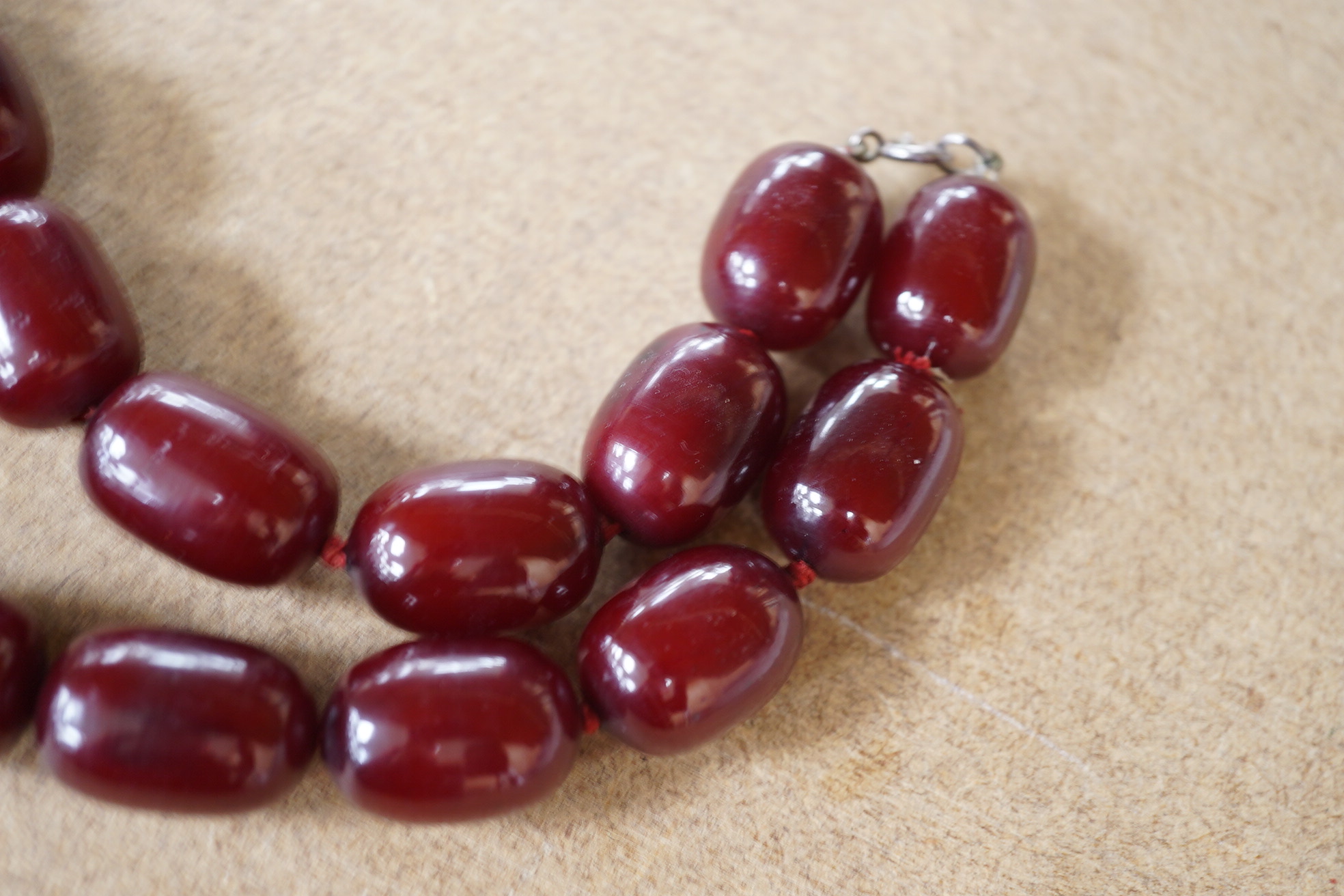 A single strand simulated cherry amber oval bead necklace, 48cm, gross weight 120 grams. Condition - fair